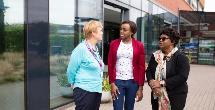 Three women outside a hospital