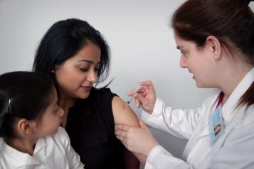 Doctor gives woman an injection