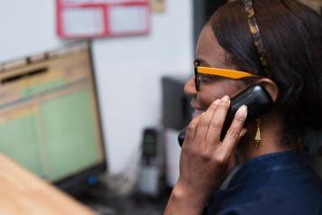 Woman talks on phone headset