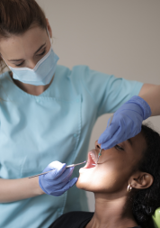 Dentist examines patient